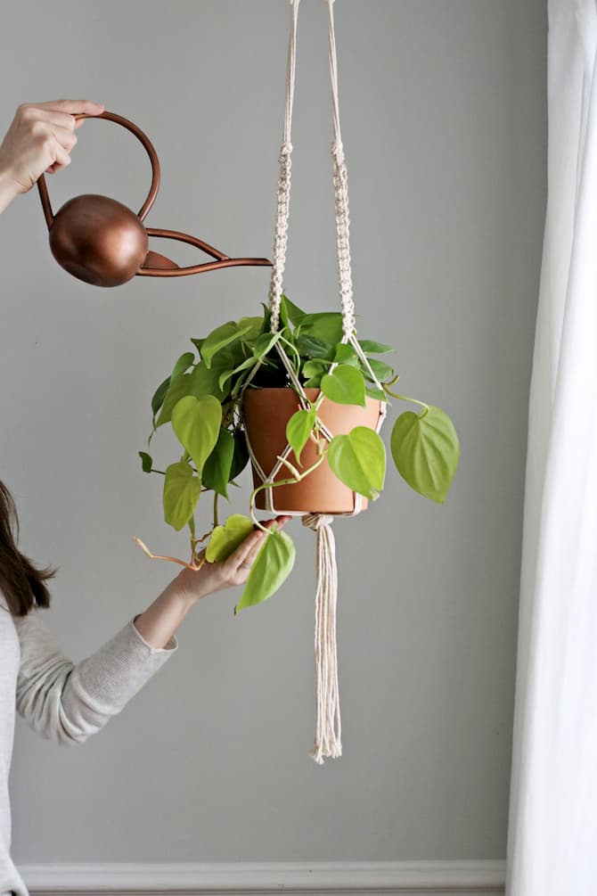 woman watering macrame plant