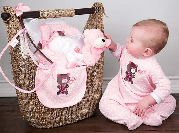 picture of a baby on wooden floor beside a gift