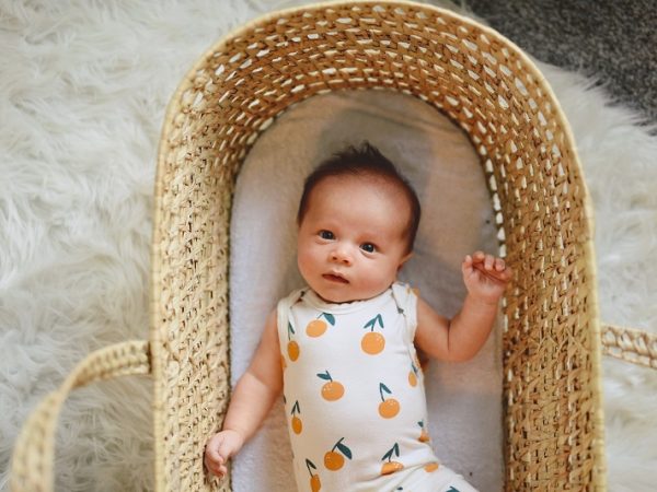 picture of a cute baby in a basket on the floor