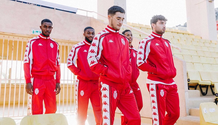 four guys walking in red kappa tracksuits
