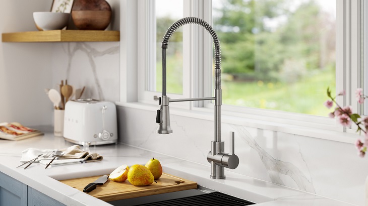 kitchen faucet with pears on board and kitchen essentials in background