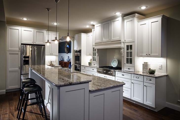white kitchen island and white kitchen with granite details