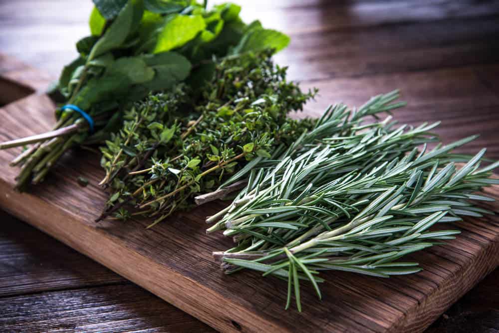 Several herbs on cutting board