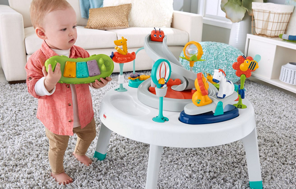 picture of a baby in front a baby activity centre in the living room