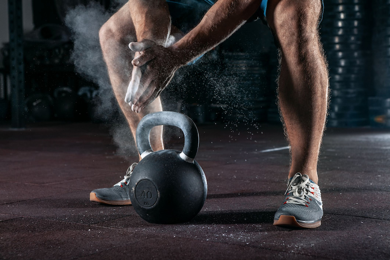 Man preparing for training with kettle ball