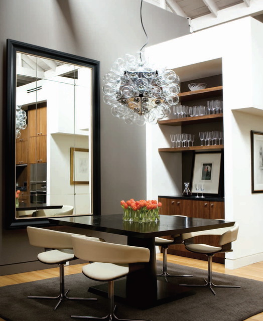 a large mirror with a black frame in the dining room