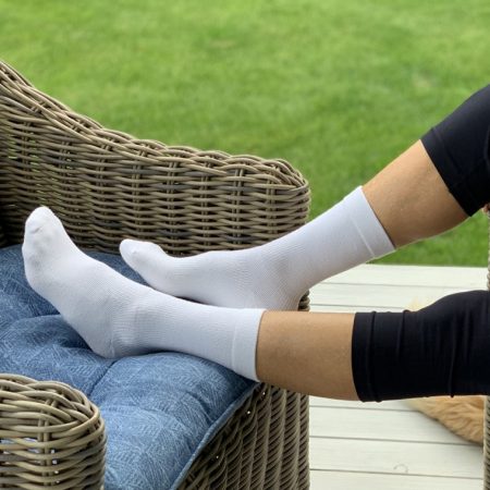 picture of a person with socks on the feet in the back yard sitting on sofa