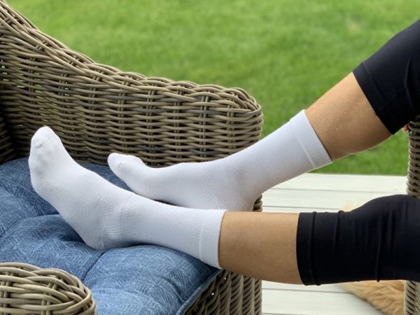 picture of a person with socks on the feet in the back yard sitting on sofa