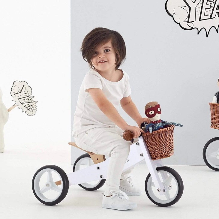picture of a kid on a white wooden trike