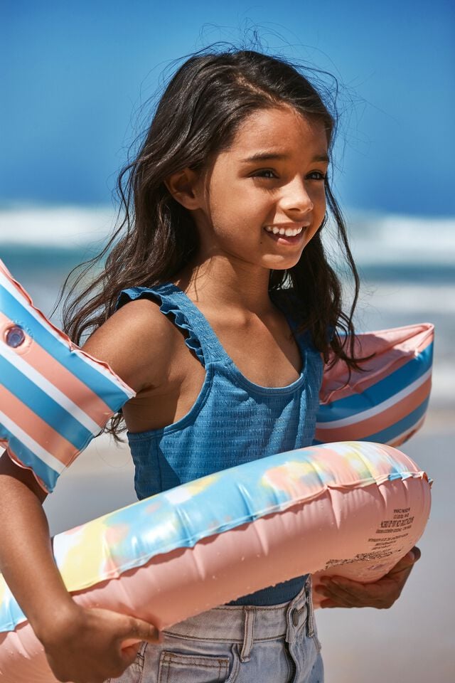 a girl wearing swim ring and armbands