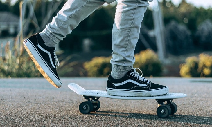 skater with vans shoes riding his skateboard
