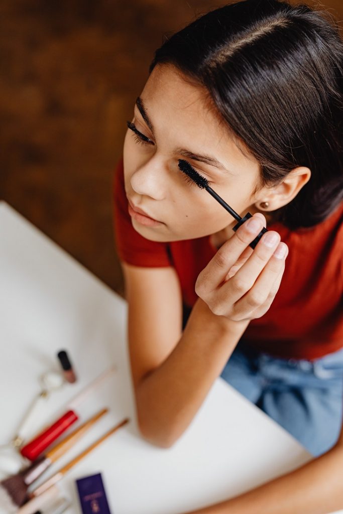 A girl applying mascara