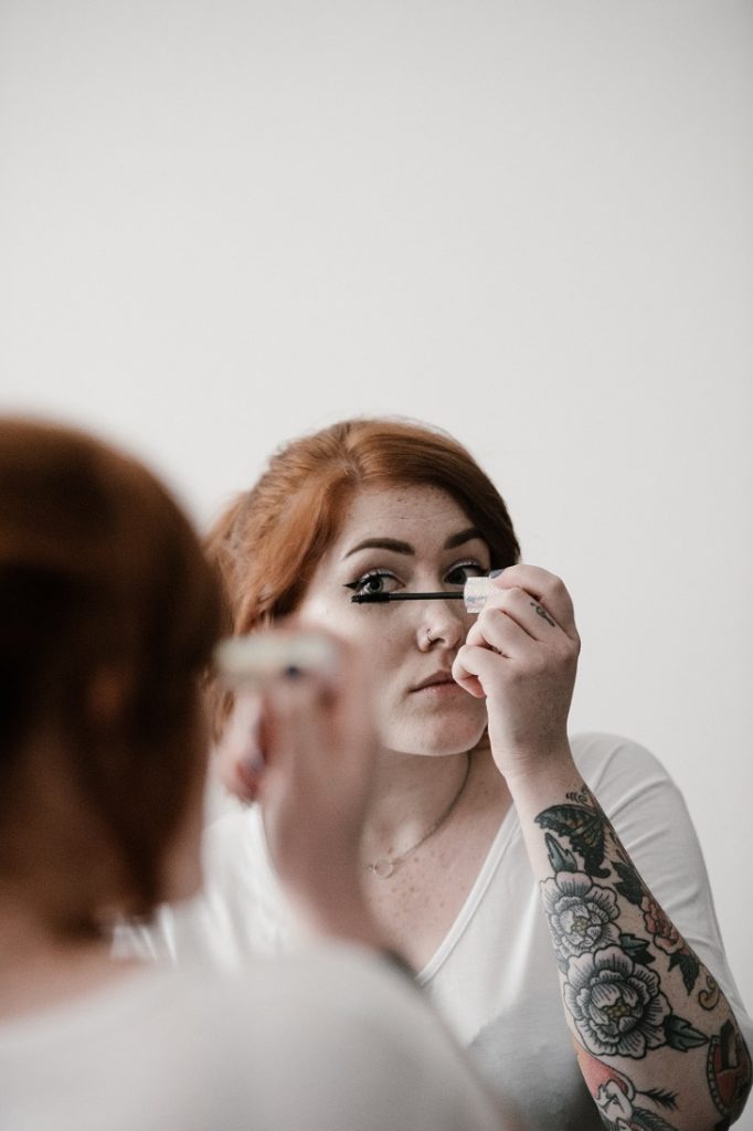 A woman applying mascara