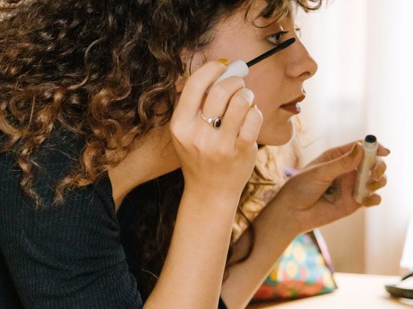 A woman applying mascara