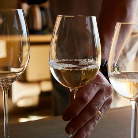 person taking the glass with sparkling wine