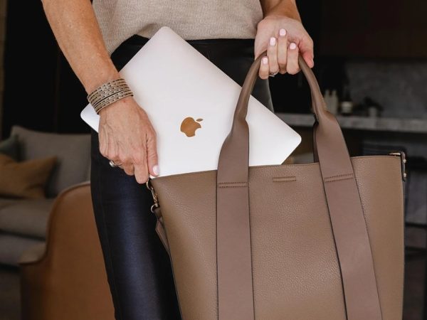 woman holding laptop bag