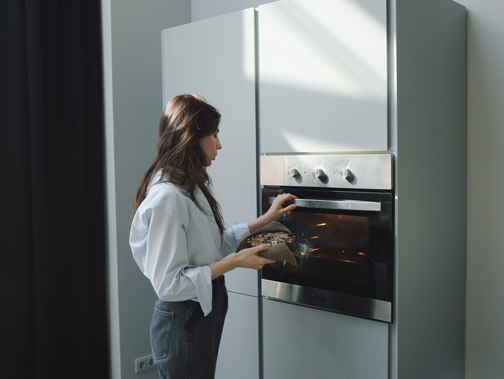 woman using kitchen oven