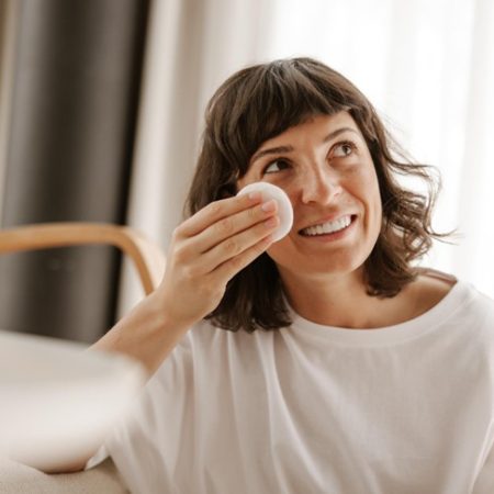 woman applying Korean face toner
