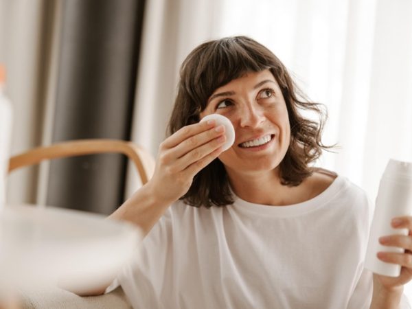 woman applying Korean face toner