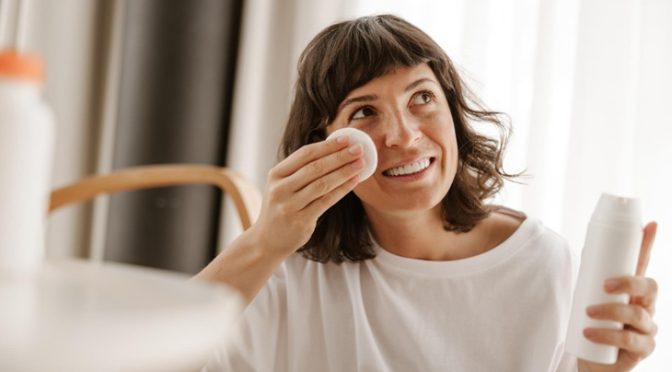 woman applying Korean face toner